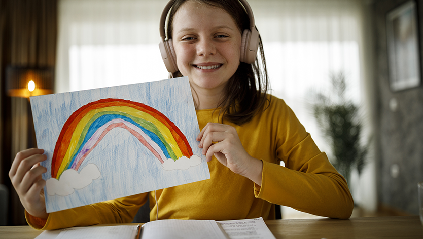 youth holding rainbow colouring